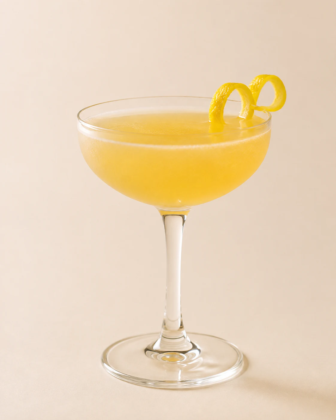 Bee's Knees cocktail, made with honey syrup, in a chilled coupe