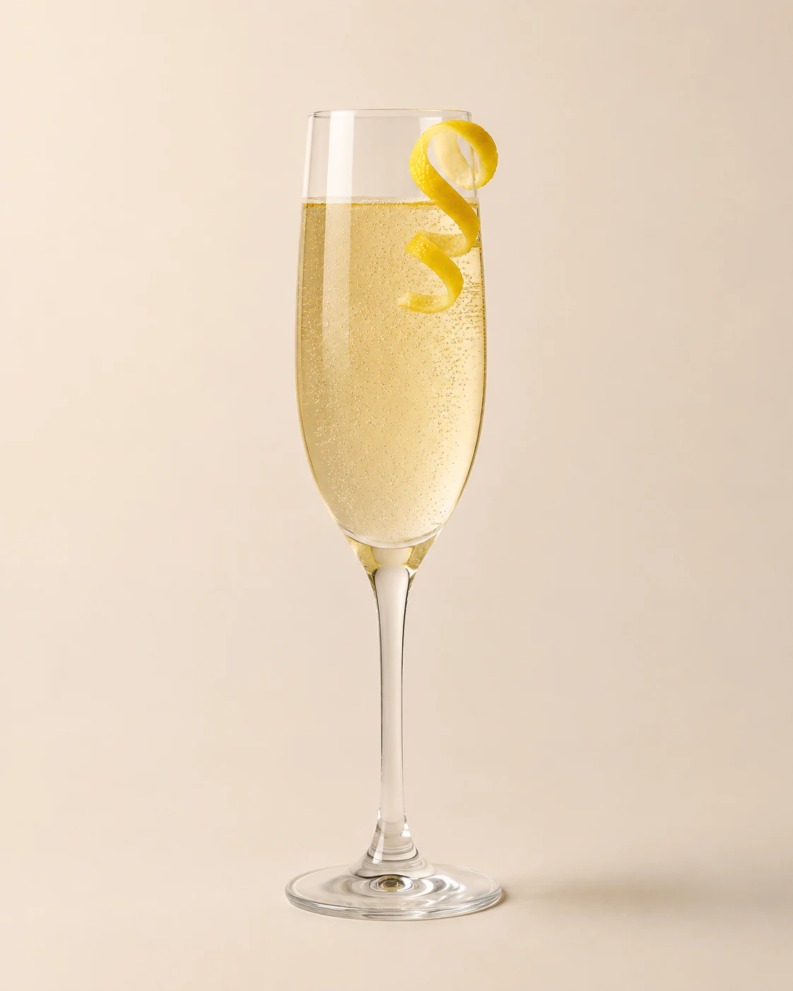 French 75 cocktail in a Champagne flute with a lemon twist