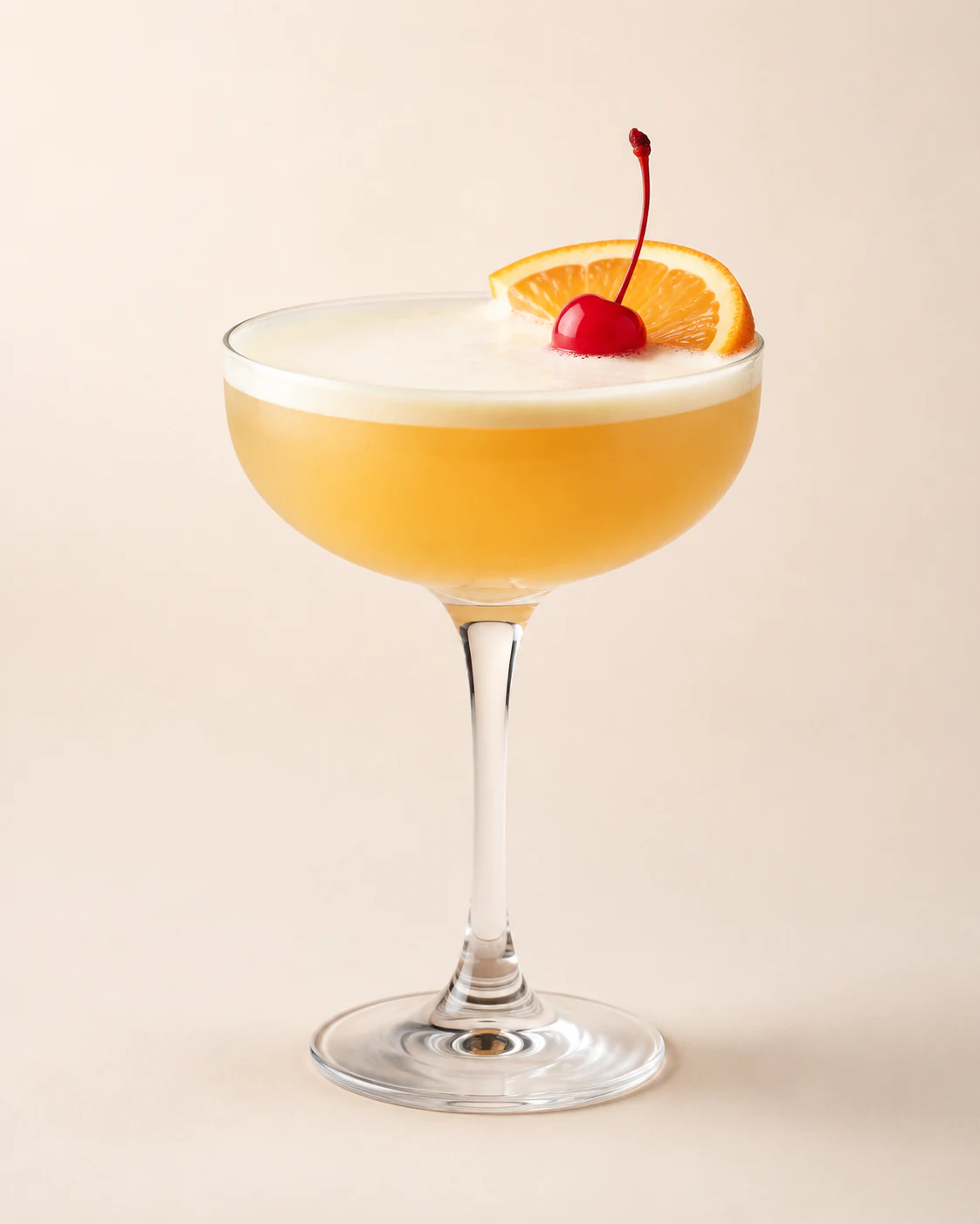 Whiskey sour with a white foam top and drops of bitters